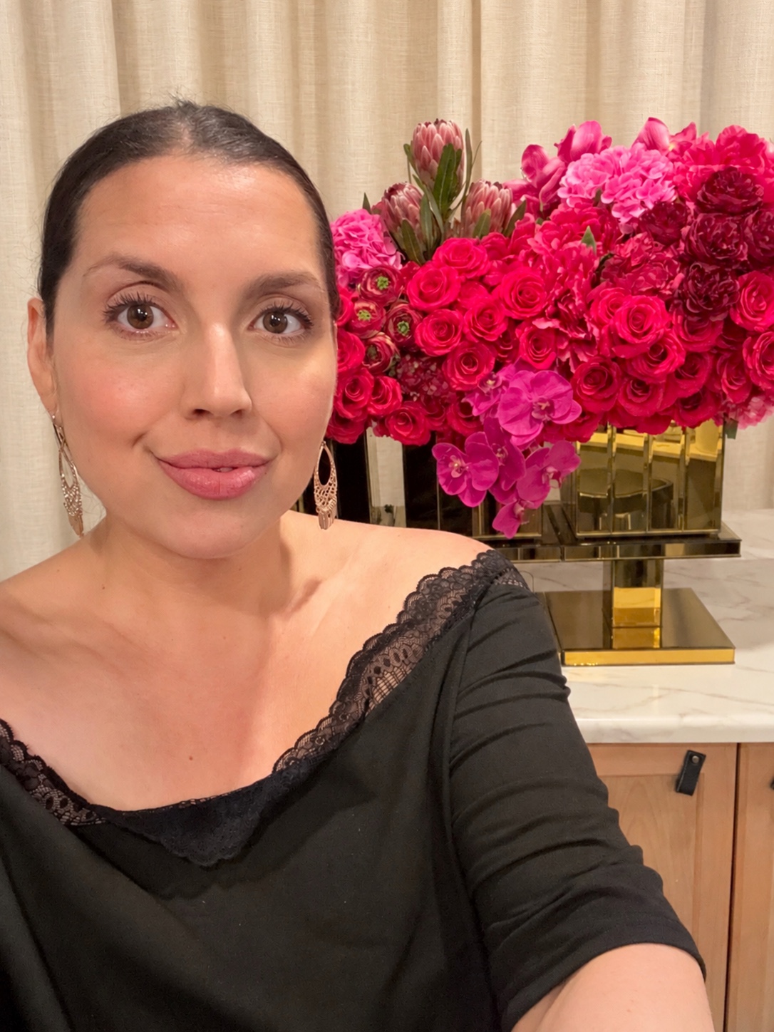 Camille Lopez pictured in front of a vibrant pink floral display