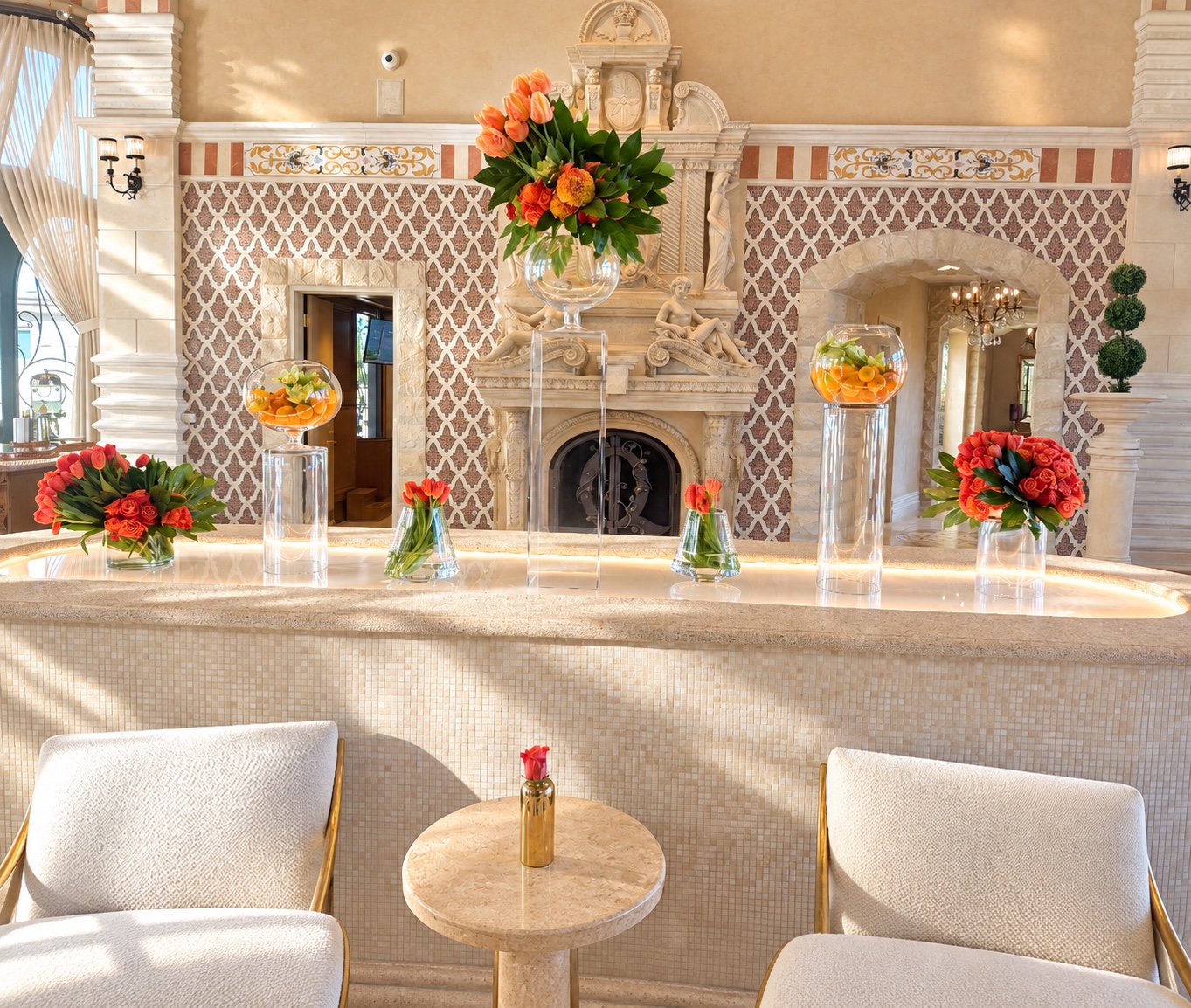 Orange floral arrangements displayed at different heights in a classical interior with ornate fireplace